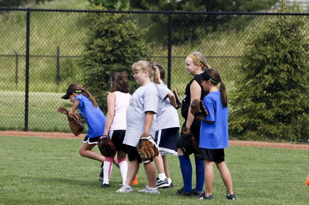 Young softball players develop their skills during a camp on GVSU's campus on June 29-30