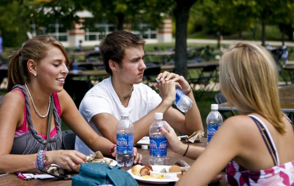 Freshmen Laura Coon, Chris Ryan, and Krystin Langerak enjoy the picnic after Convocation