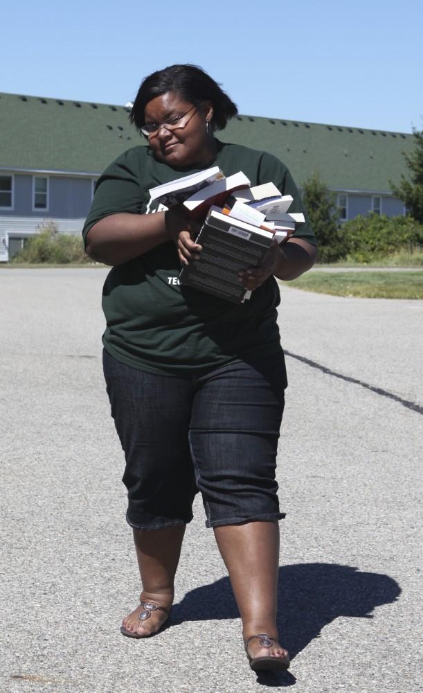 Student Shannon Gibson struugles with the weight her teachers have put in her arms.
