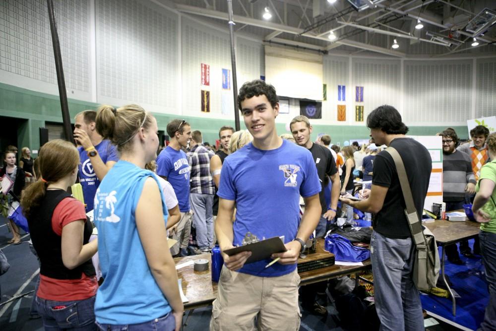 Marco Benedetti and other GVSU Rowers talk to students interested in joining the crew during campus life night.