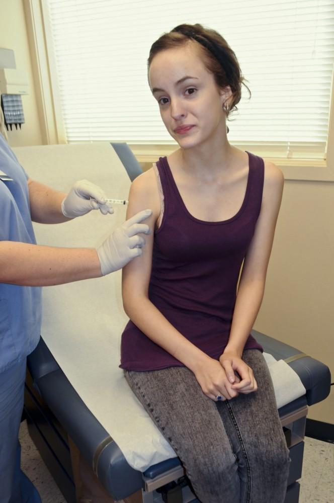 Junior Amber Spencley receives a flu shot at the Campus Health Center