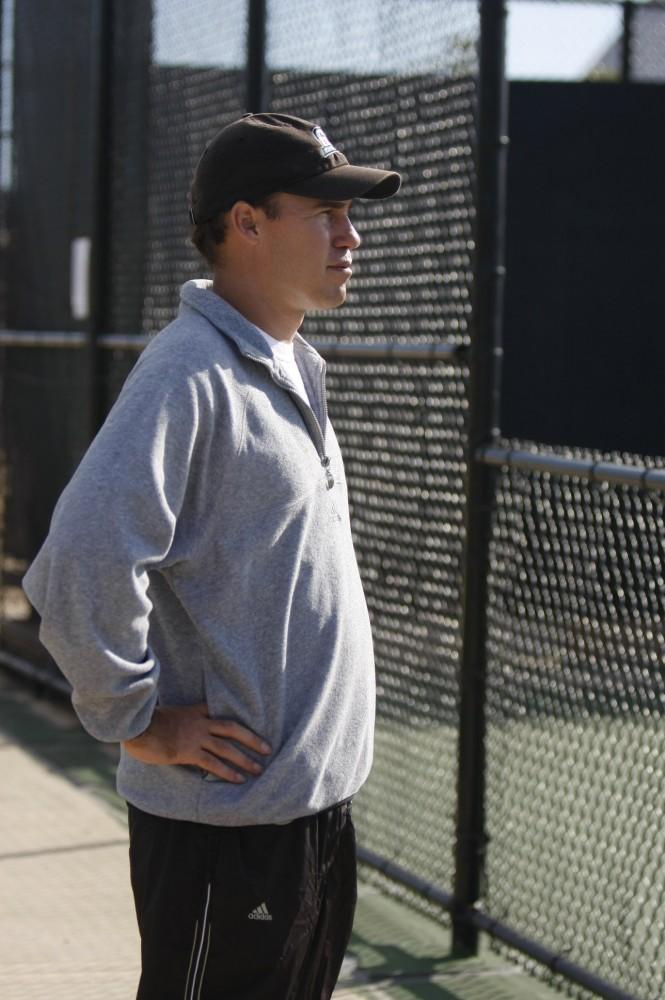 Tennis Coach John Black surveys his players during practice
