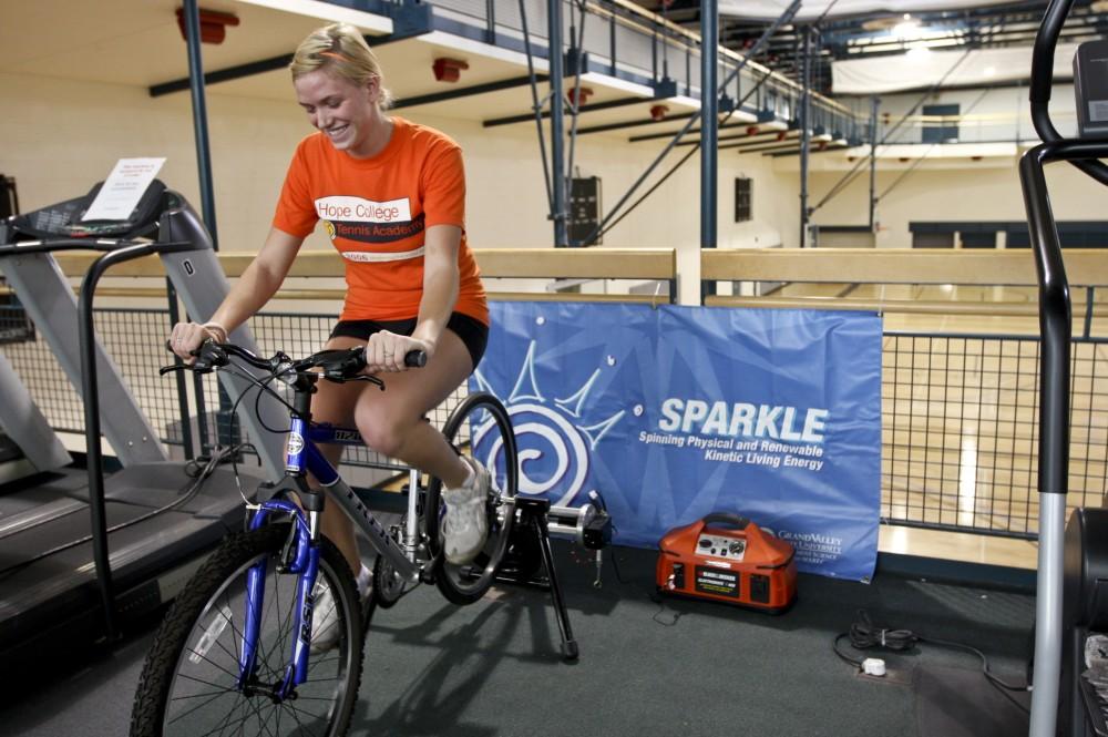 GVL / Eric Coulter
GVSU student Briana Vanderwege uses the energy creating bike SPARKLE