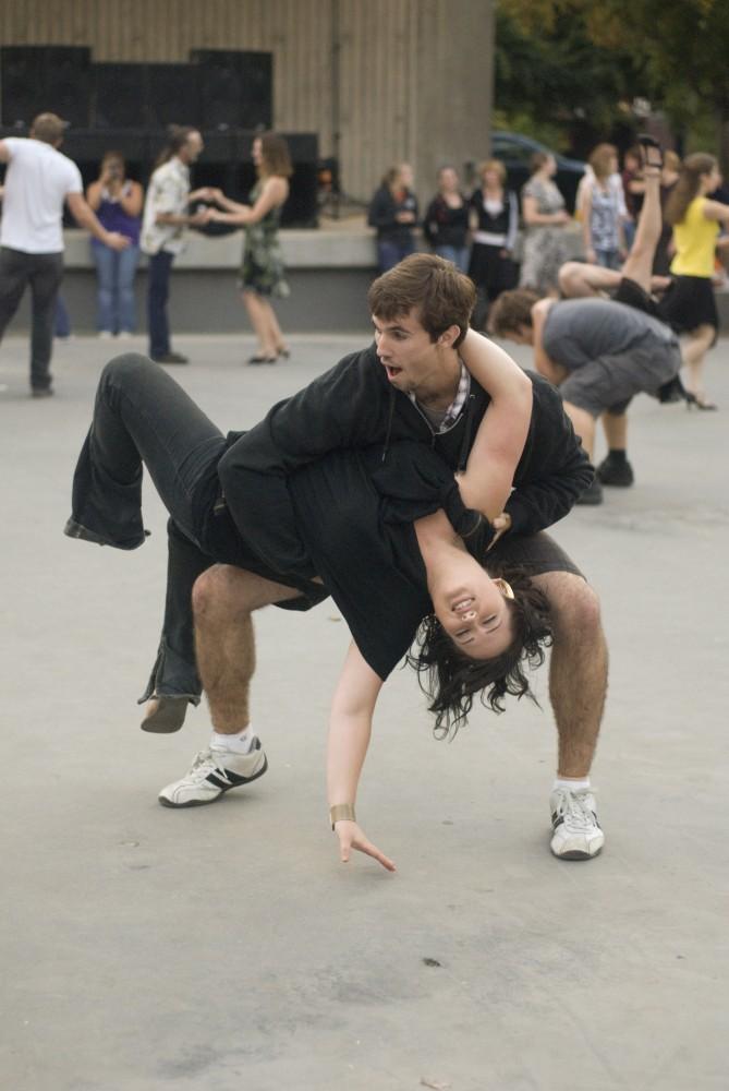 Lauren Degraaf (L) dances with Cloud Cray (R) during Tuesday nights swing dancing hosted by the Grand Rapids Original Swing Society at Rosa Park Circle in downtown Grand Rapids.
