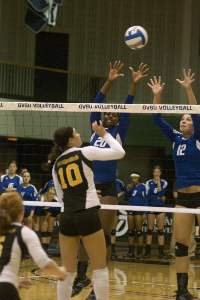 Grand Valley State University sophomore Eno Emoh (L) and senior Leslie Curtis (R) both jump for a block during the Laker’s defeat of Michigan Tech on Saturday afternoon.
