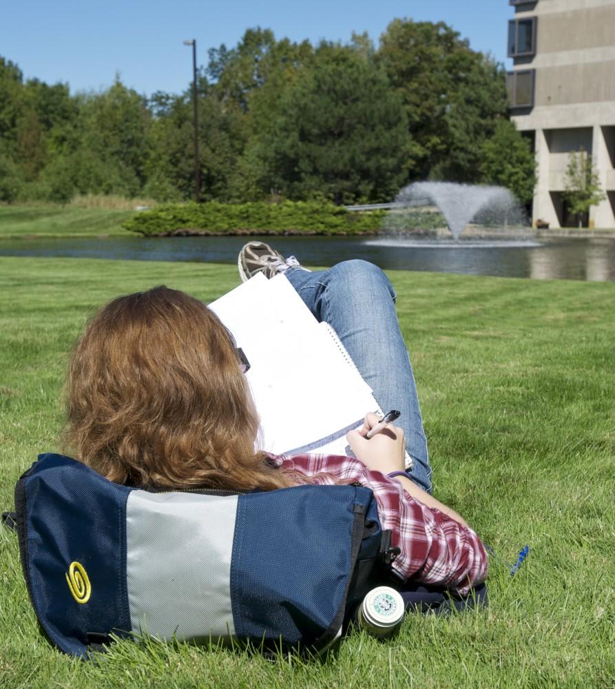 Sarah Watson writes near the Zumberge Pond