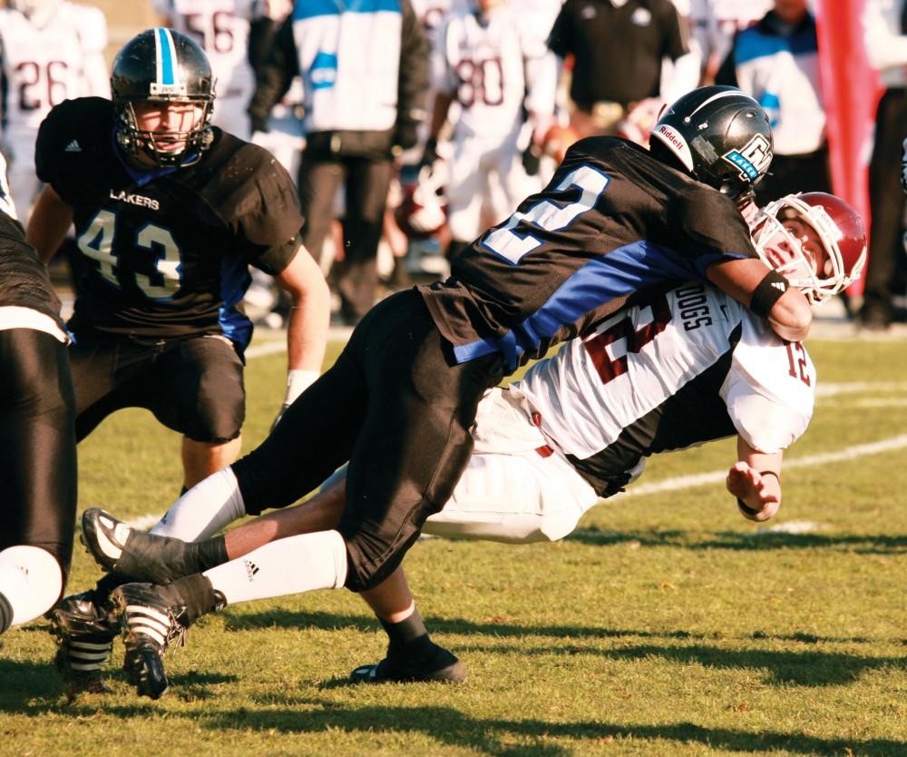 Archive Courtesy Photo/ Jeremiah Schrader
Robert Carlisle brings UMD quarterback Ted Schlafke down during the playoff game in Allendale last Saturday. 