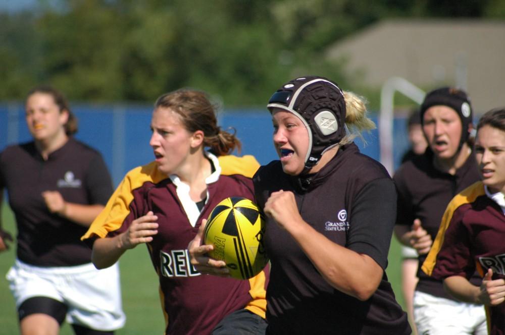 GVL Archive / Lindsey WaggonerGVSUs womens rugby team played CMU on Saturday. GVSU player runs for the goal as Rebels try and catch her.