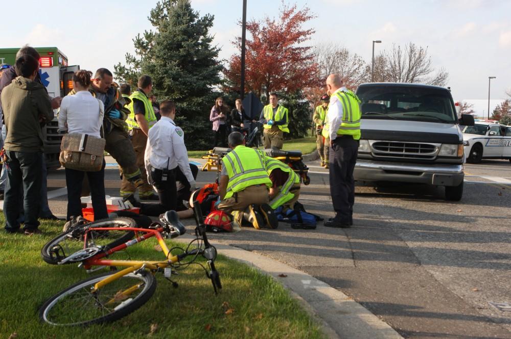 Fire and Rescue tend to the victim as students watch 