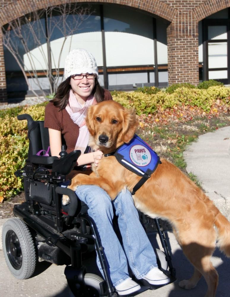 Ashley Wiseman poses with her guide dog Maui