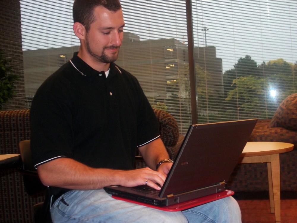 Ryan Lillibridge with the pad that stops harmful exposure to notebook computers. 