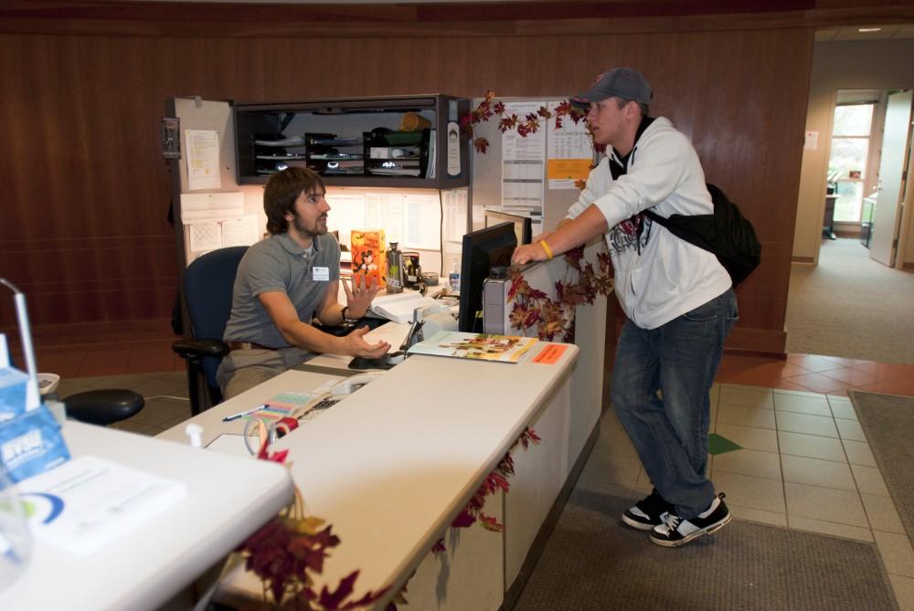 Junior sports management major Josh Schutt asks for grant information in the Financial Aid office.