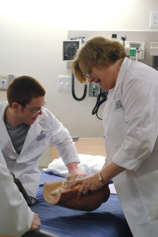 GVL Archive / Katie Mitchell
Professor Deborah Bambini works with nursing student Rob Froh on injections areas in lab.