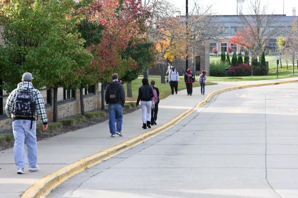 Students use the sidewalk by the Kirkhof bus loop