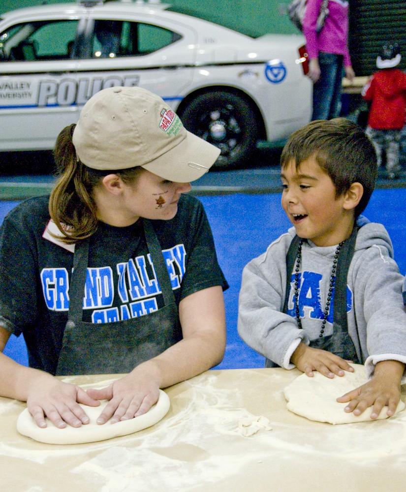 A little Laker spreads out some pizza dough during the Tip-Off madness