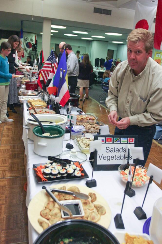 A participant at the International Reception enjoys the spread of food from around the globe