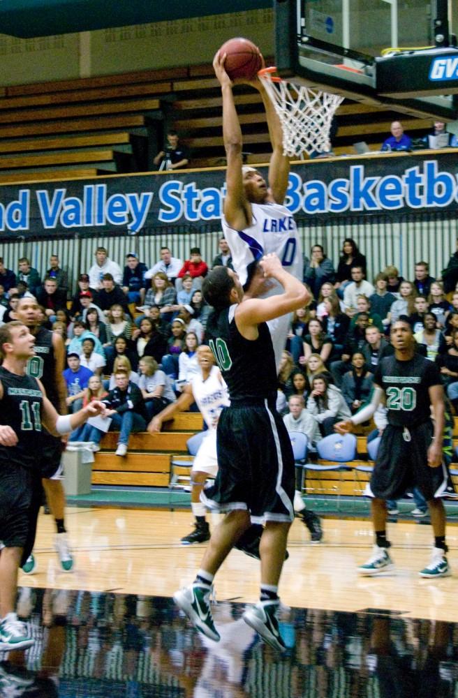 GVL Archive / Brian B. Sevald
GVSUs KLen Morris jumps for a layup against Wayne States heavy defense in a past game