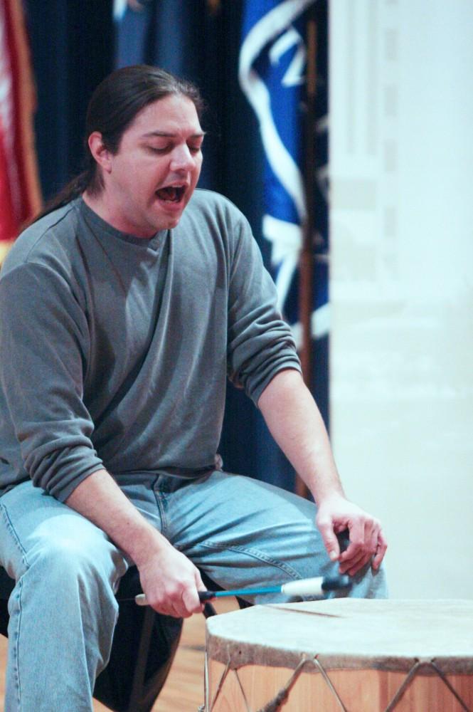 A native performer plays traditional drums to open up the screening of "The Reel Injun"