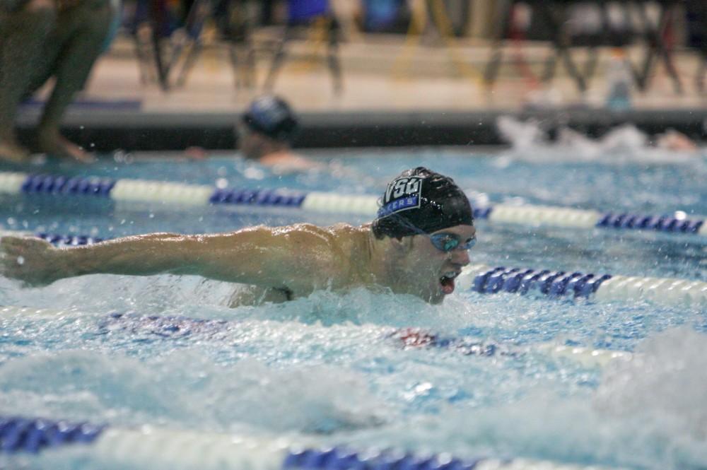 GVL Archive / Eric CoulterA GVSU swimmer lunges forward through the water at a past meet. Grand Valley State University lost 149-87 to Michigan State University.