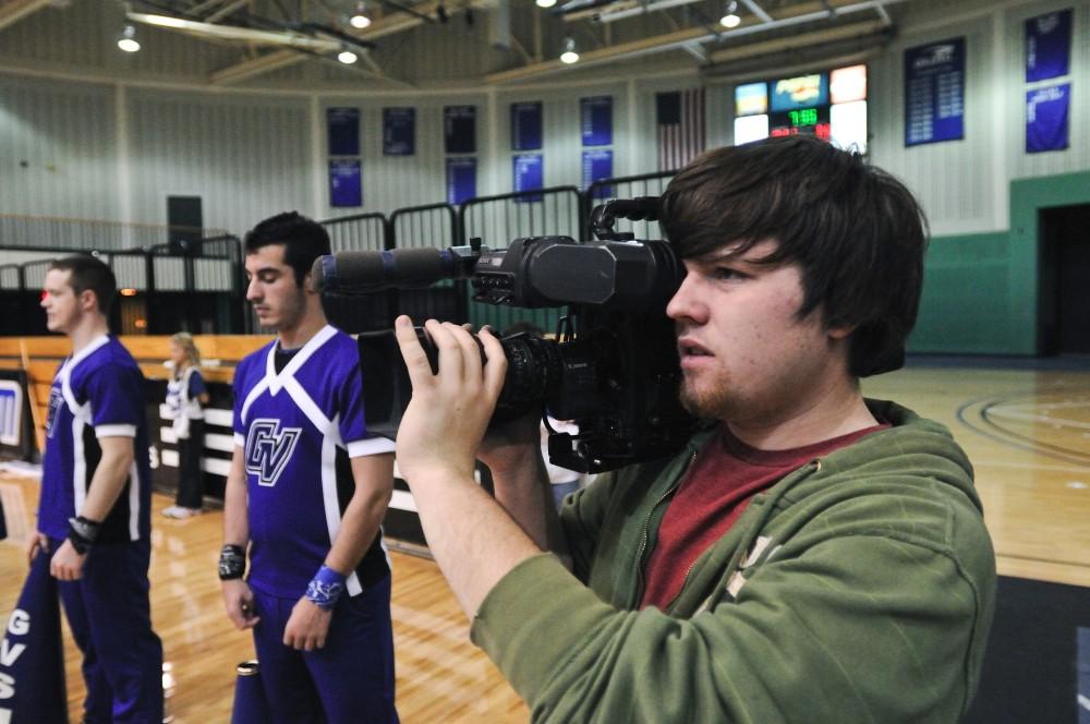Andrew Murray, both a GVSU student and WGVU employee, films a basketball game in the Fieldhouse.