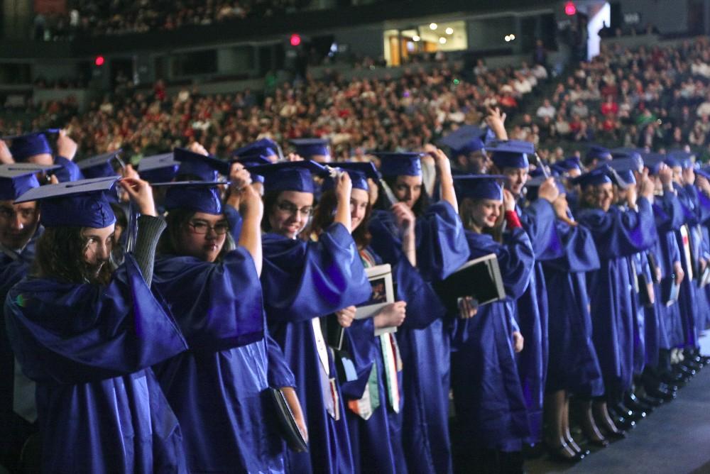 The graduates turn their tassles as commencement comes to a close