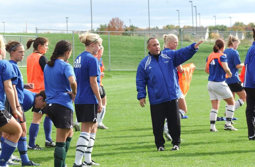 GVL Archive / Taylor RaymondGirls head soccer coach Dave DiIanni tells players what to focus on before their scrimmage during practice.
