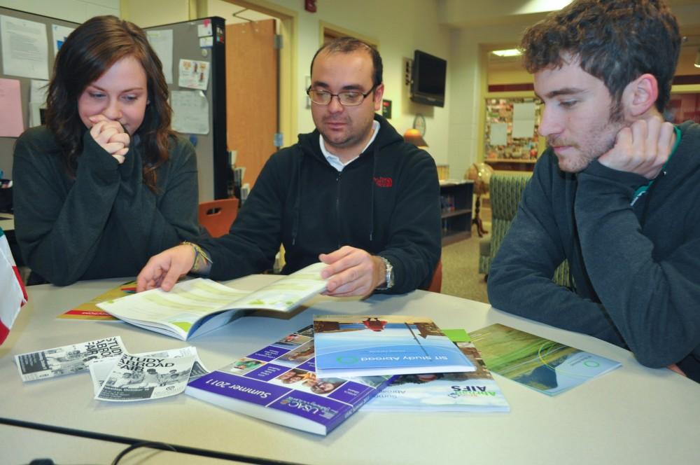 J. Ortiz-Estevez teaches Maggie Overbeek and Kyle OBrien about the study abroad program