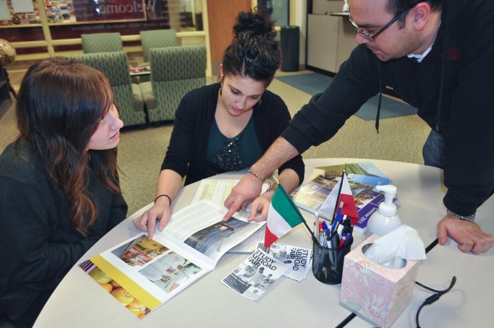J. Ortiz-Estevez and Annie Hakim help Maggie Overbeek learn about the study abroad program
