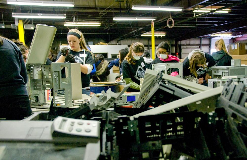 GVSU volunteers participate in the day of service and help local business Comprenew recycle electronic devices