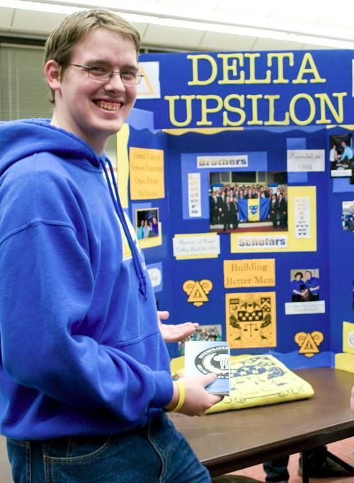 Ryan Cronk, member of Delta Upsilon, takes a break from talking to students to pose for a photograph during Meet the Greeks