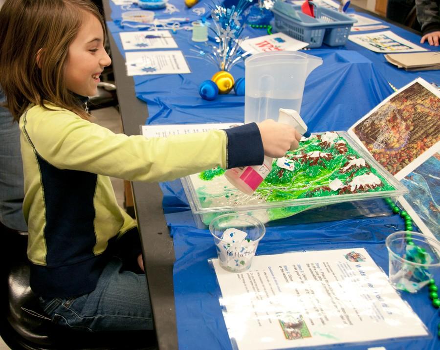 Katie Johnson, 8, performs an experiment with water during Super Science Saturday