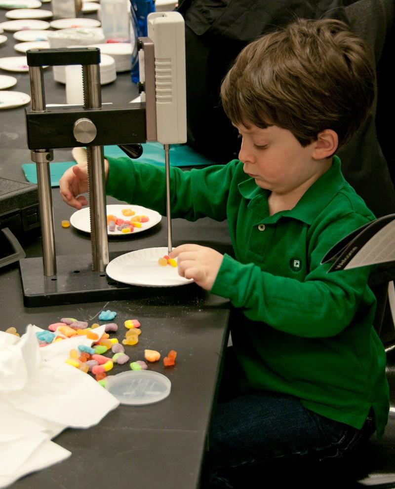 Alec Berlingieri, 5, performs an elaborate experiment with some candy during Super Science Saturday