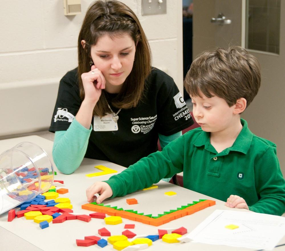 Mackenzie Majeske helps out little 5 year old Alec Berlingieri during Super Science Saturday