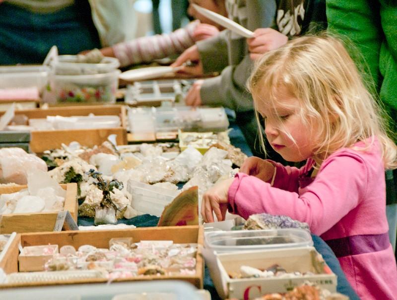 A future Laker and Geology major inspect some minerals during Super Science Saturday