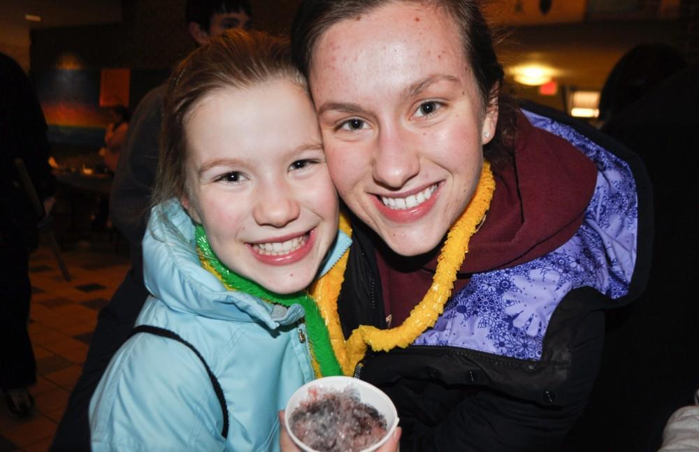 Hannah Quist and her younger sister Morgan enjoy free snow cones at Sibs and Kids Weekend