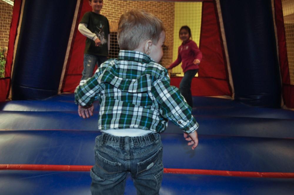 A tiny laker gets ready to explore the giant moon bounce in Kirkhof