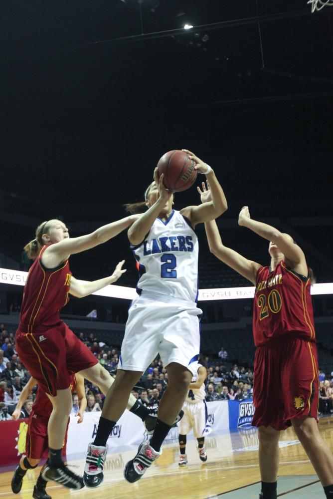 Brittany Taylor makes an attempt at a basket with defenders closing in on both sides