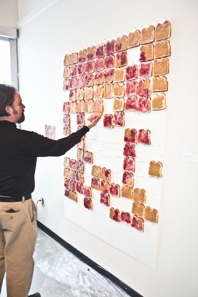 GVL Archive / James Brien
A spectator removes some of the bread from an art piece featured in last years Eating the Art exhibit