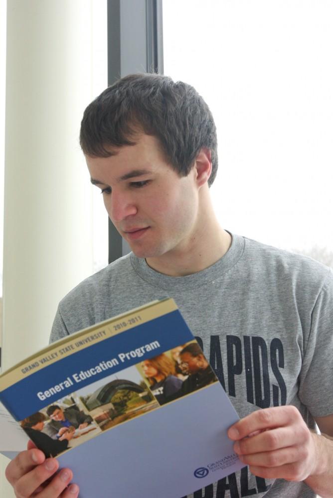 Grand Valley student Justin Willmannreads over the General Education requirements. The university has recently adjusted some of the requirements. 