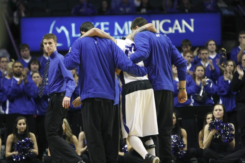 Teammates help K'Len Morris off of the court after an injury during the 131 showdown