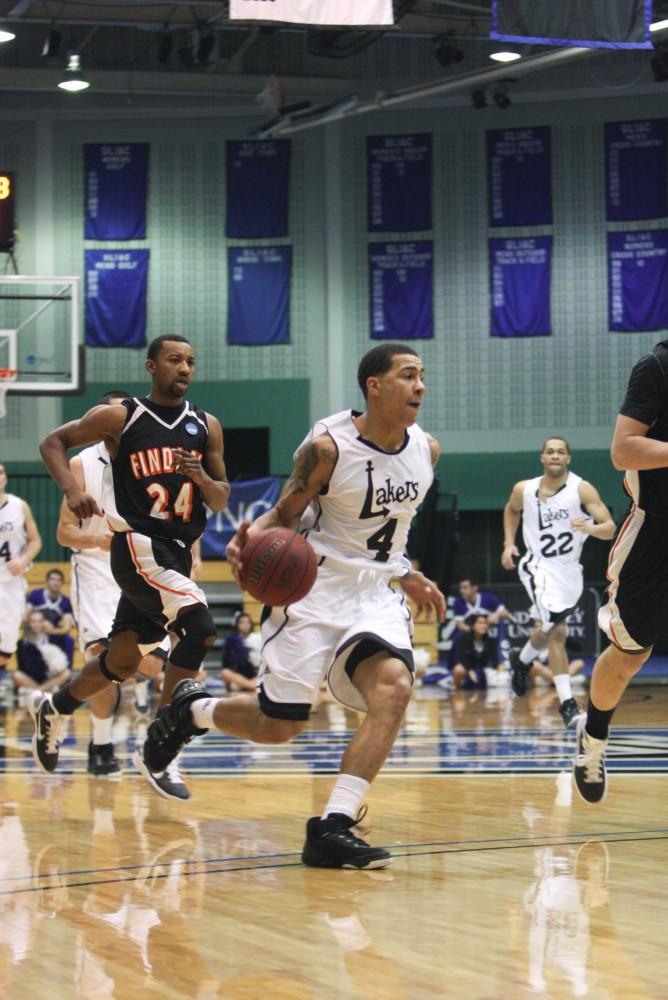 Junior James Thomas brings the ball up the court during Thursday's match up against Findaly. The Lakers were victorious 72 - 66