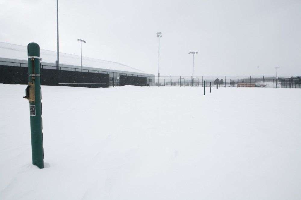 Snow blankets the GVSU tennis courts, forcing players to travel downtown to practice