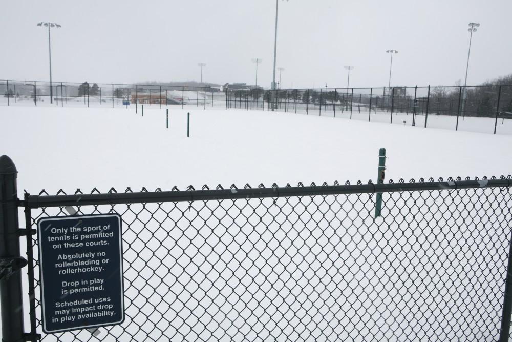 GVL / Eric Coulter
Snow blankets GVSUs tennis courts. The players must travel to Grand Rapids to practice indoors