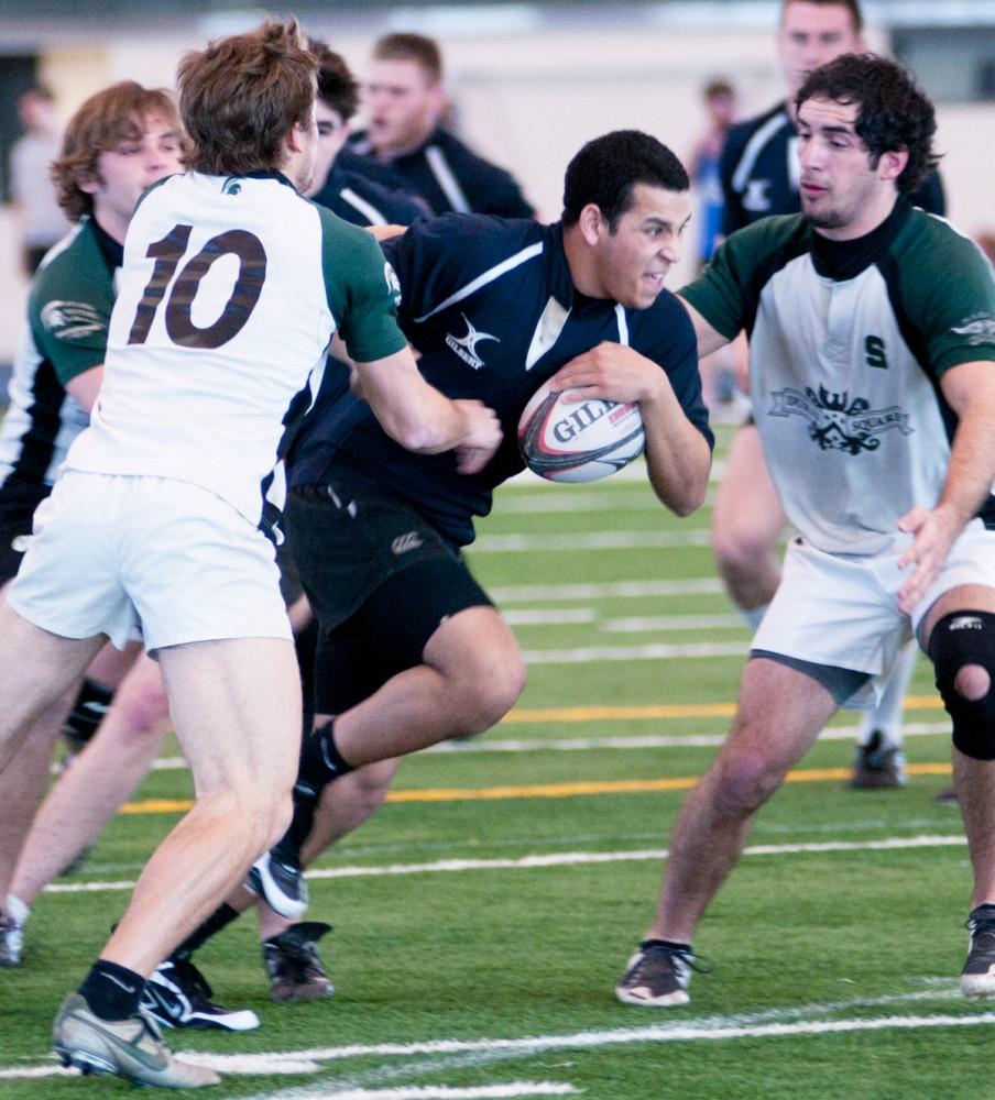 A member of the GVSU Rugby team evades the MSU players during Saturdays game