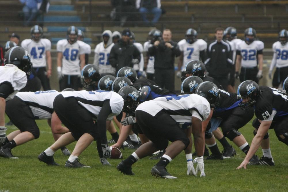 Both the offense and the defense line up before the start of the play during the Sping game on Saturday.