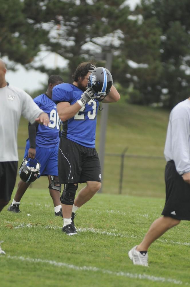 GVL/ Rane Martin
Senior lineman Danny Richard puts his helmet on before beginning warm-ups during practice on Tuesday.