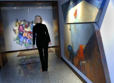 Artist Gretchen Minnhaar in the hallway outside her penthouse at the top of Plaza Towers.  Because of the size of her pieces Minnhaar keeps her artwork in the entranceway.  
(Press Photo/Katy Batdorff)
