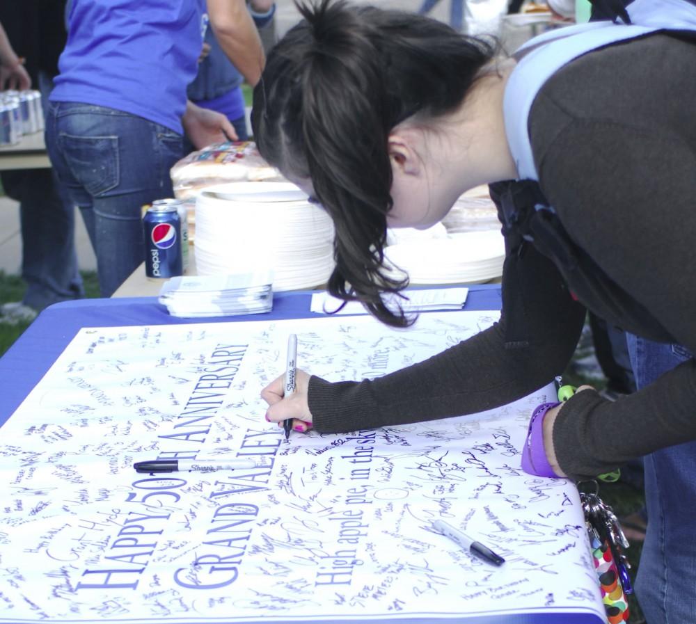 GVL Archive / Nicole LamsonStudents signing Grand Valleys 50th Birthday Card