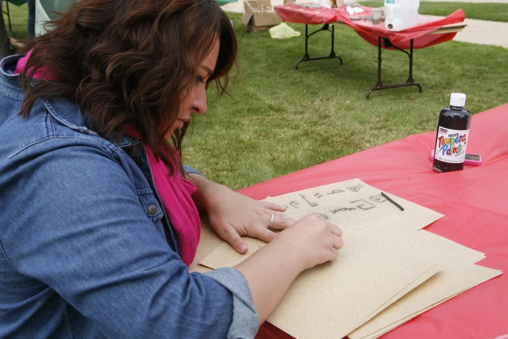 GVL/ Eric Coulter
Former Archaeology club president Ashley Taylor draws some hieroglyphics during the Paleo-olympics as a part of Archaeology Week. 