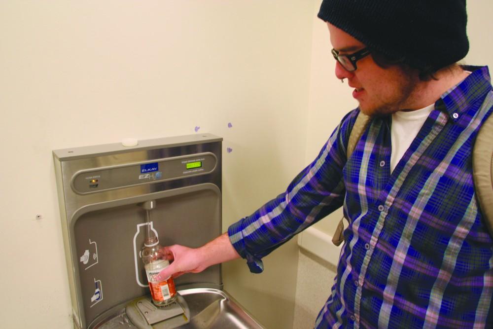 GVL/ Dylan Graham
GVSU student Damon Graham fills his empty water bottle at the the new water-bottle refilling station located in Mackinac.